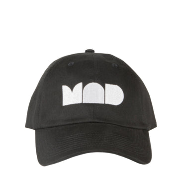 This is an all black cap, front facing, with MAD museum logo. The logo is only the three letters (MAD)  in a large embroidered block/filled font. The embroidery is in white.